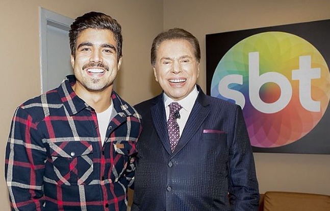 Garoto-propaganda da Tele Sena, Caio Castro posa ao lado de Silvio Santos